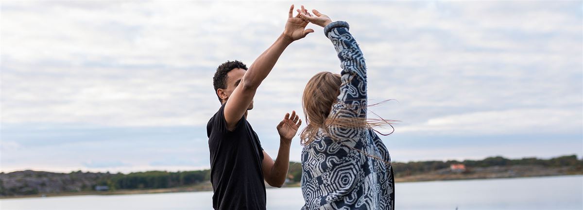 Couple dancing with joy by sea