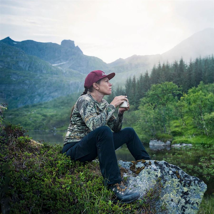 Woman enjoying a cup of coffee on a mountain
