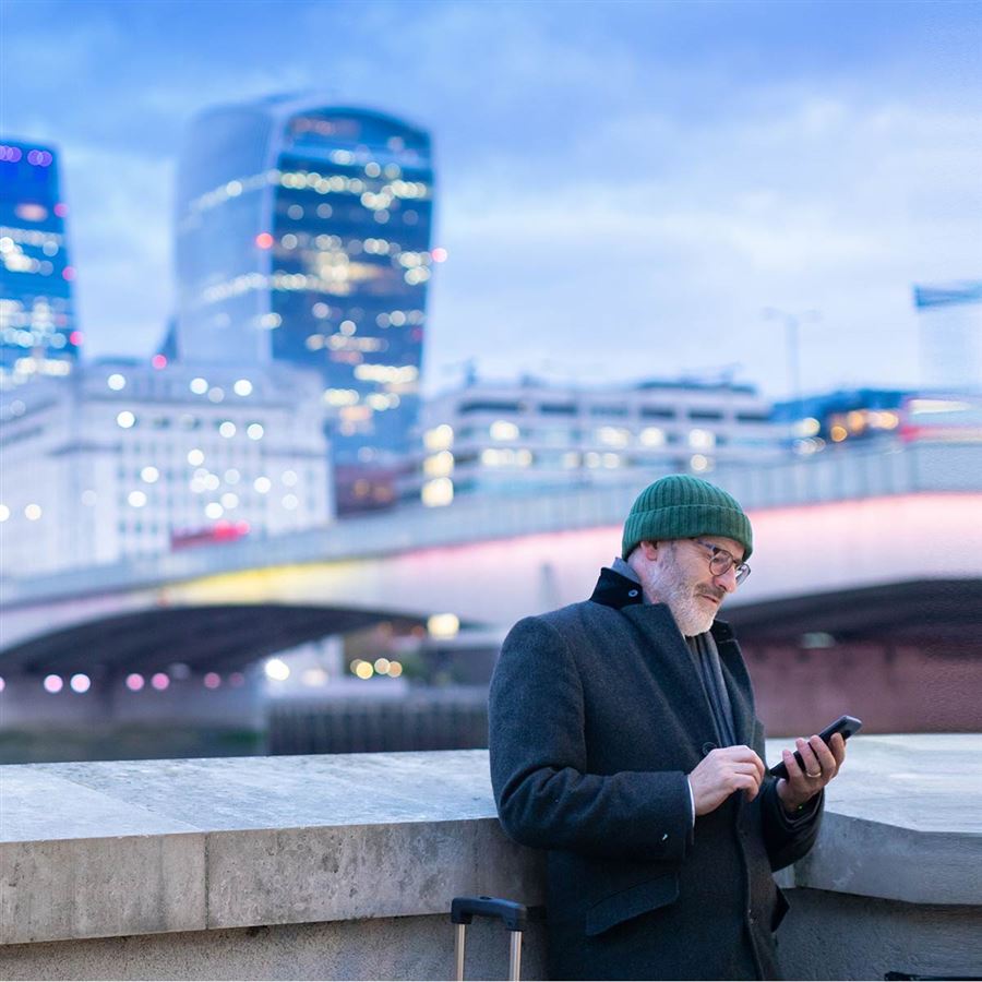 Traveling man looking for directions on his phone