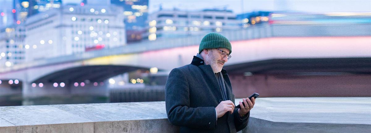 Traveling man looking for directions on his phone