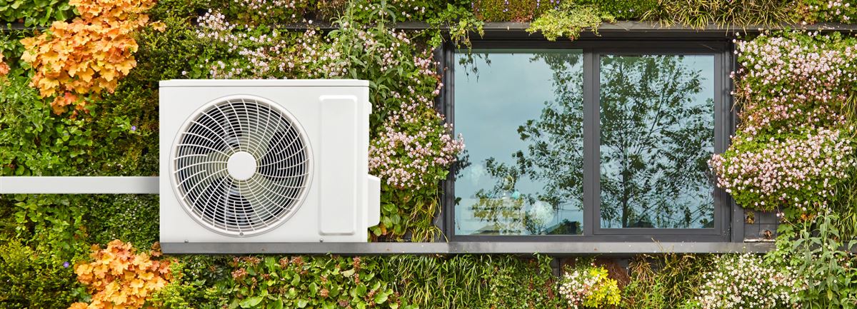 Ventilation unit on green and flowery property