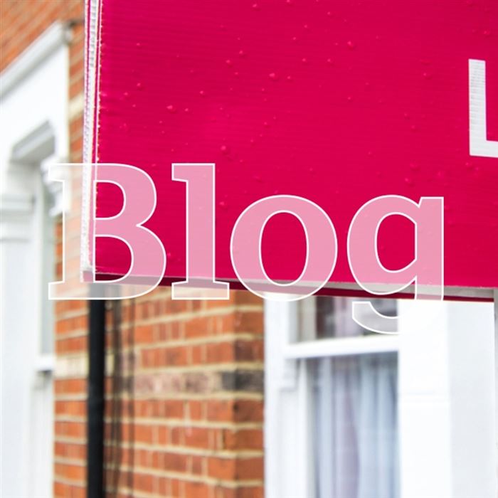 Pink 'To let' sign outside a property