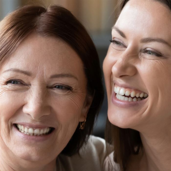 Mother and daughter smiling