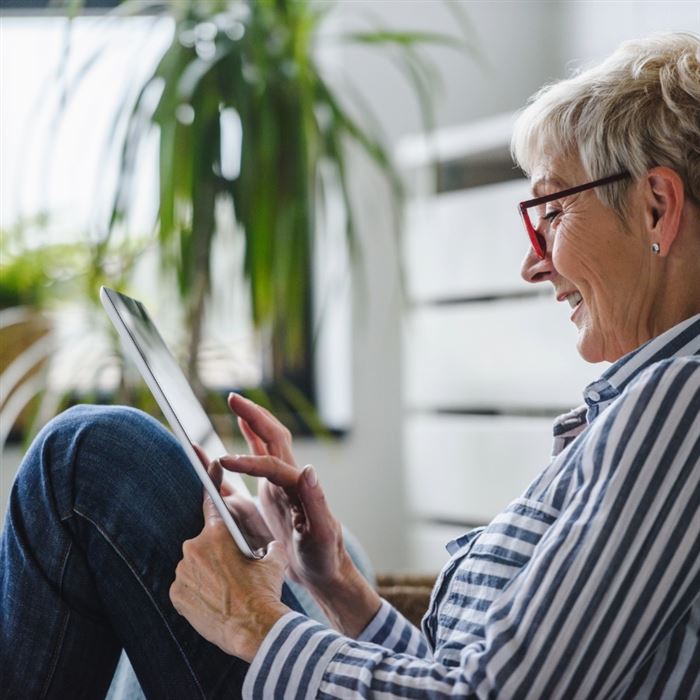 Mature woman browsing on ipad