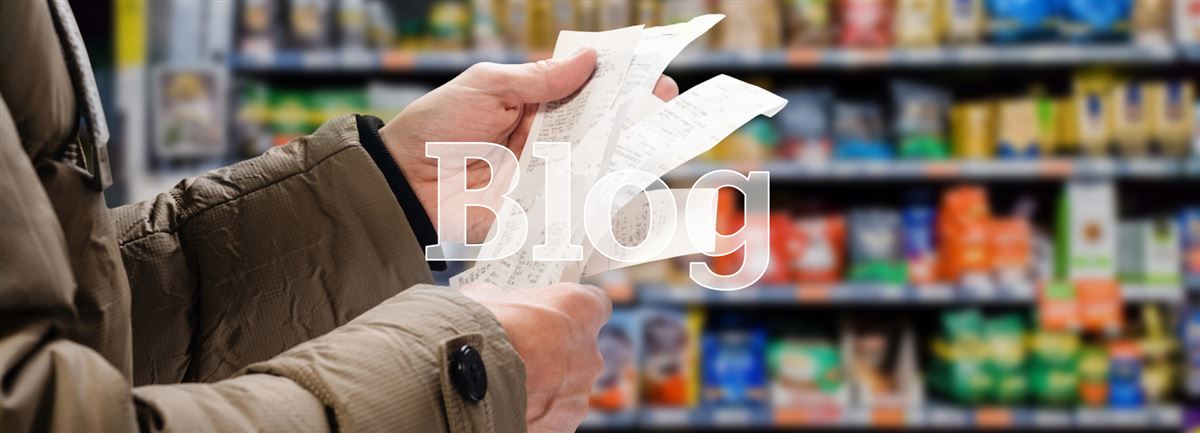 Man looking at receipts in supermarket