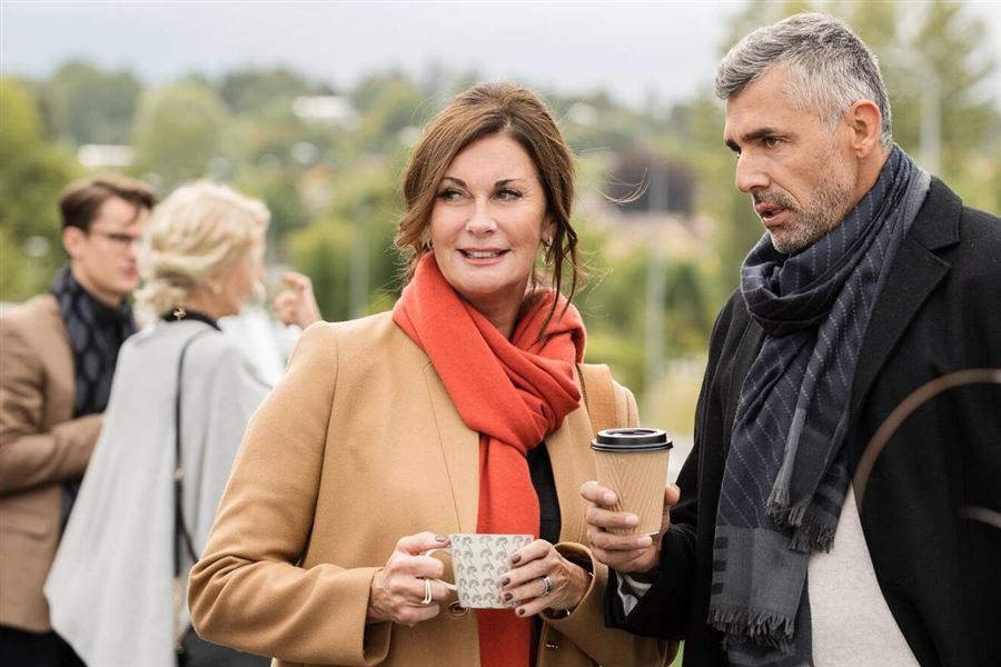 Man and woman outside having a coffee