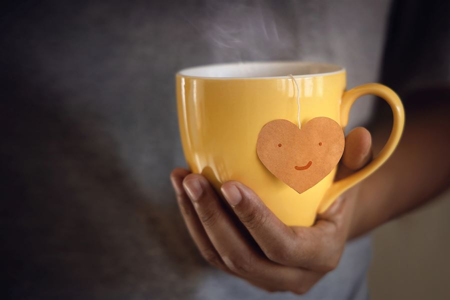 Man holding yellow cup