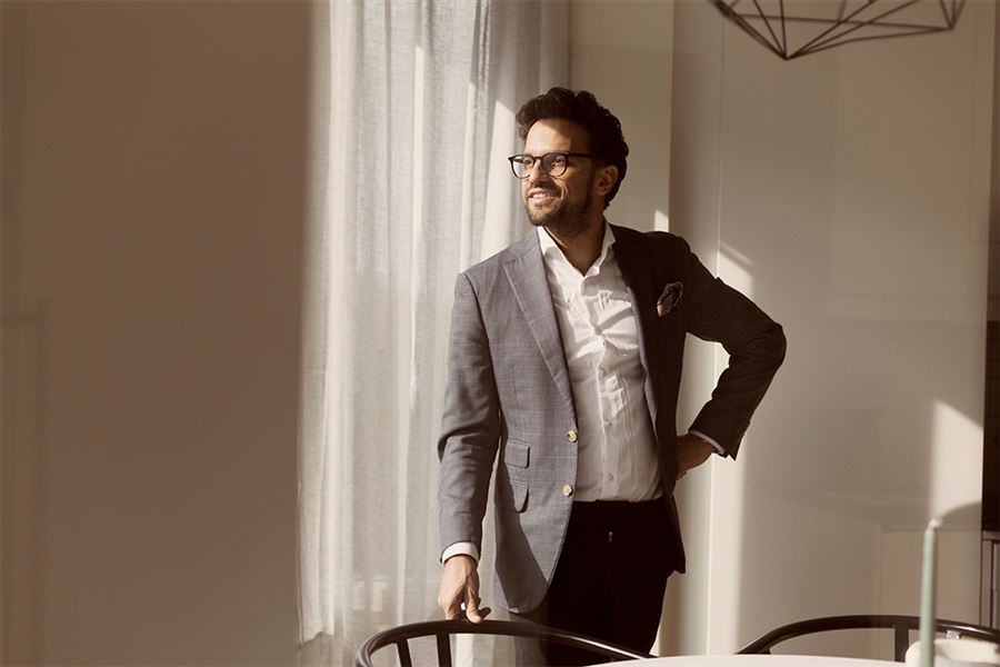 Man in suit and glasses smiling