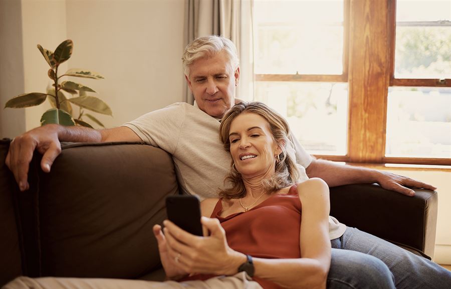 Happy couple looking at mobile phone