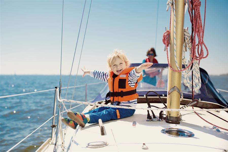 Happy child sat on boat